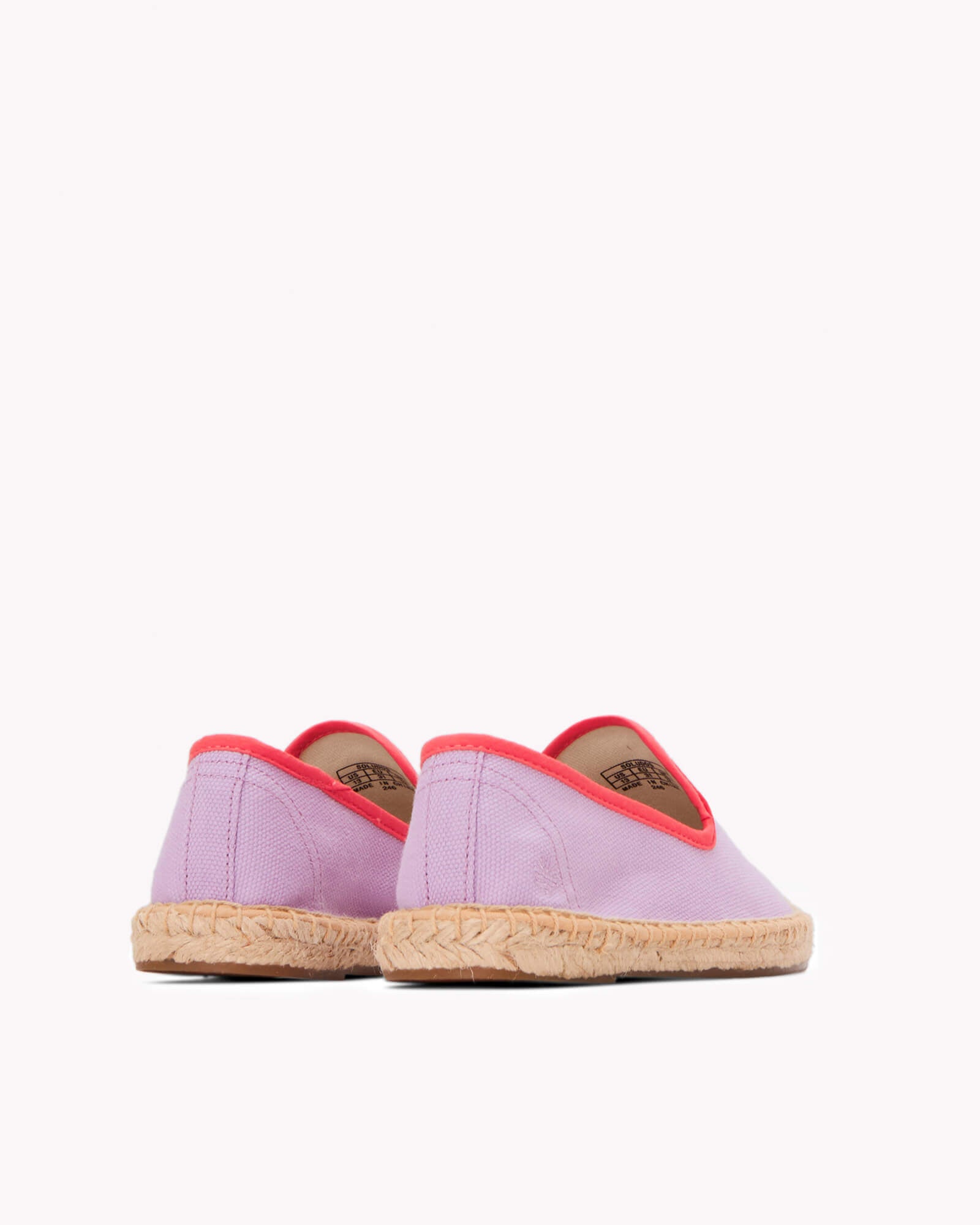 Kids lavender espadrille shoes with red piping on gray background