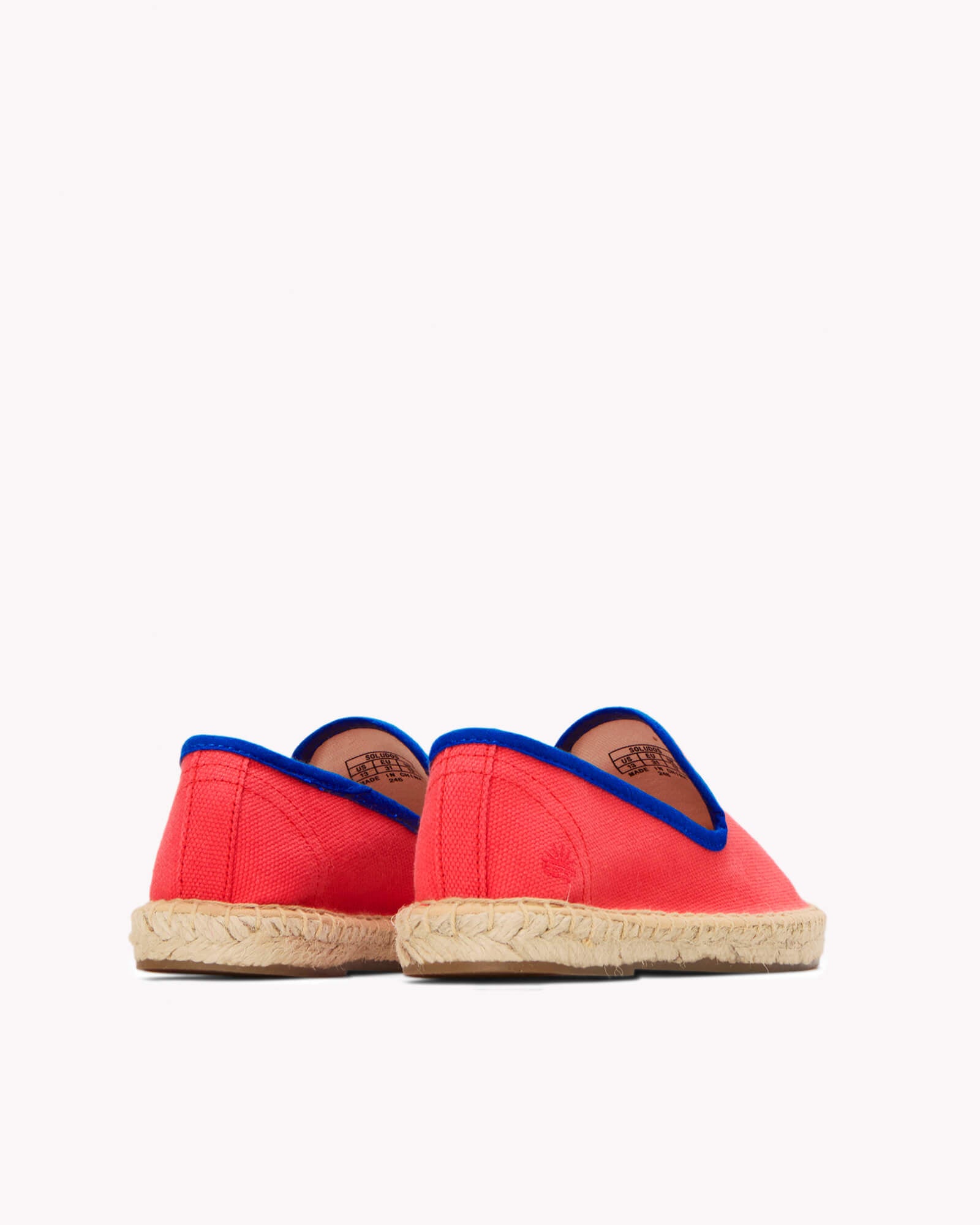 Kids red espadrille shoes with navy piping on gray background