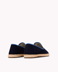 Men's navy espadrille shoes with blue piping on gray background