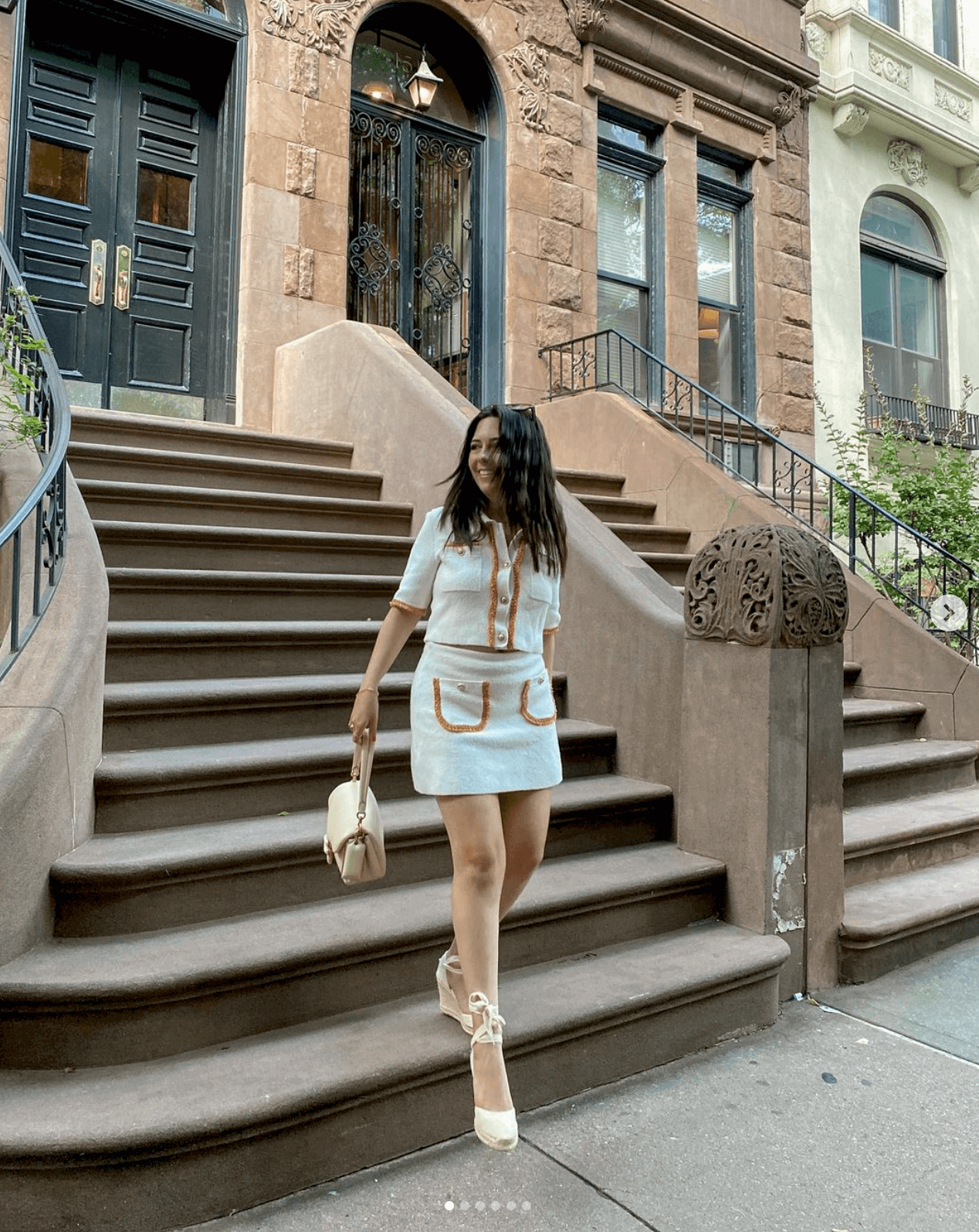 Woman wearing ivory espadrille wedges in an ivory outfit with yellow trim in UGC style